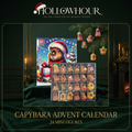 The capybara advent calendar box beside its tray of 24 capybara mini figures, some hanging from a pine branch