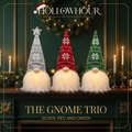 Three light-up knitted gnomes in silver, red and green standing in a row on a mantel