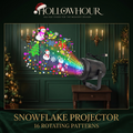 The snowflake Christmas projector on a side table, throwing snowflake, snowman and tree patterns across a dark green panelled wall
